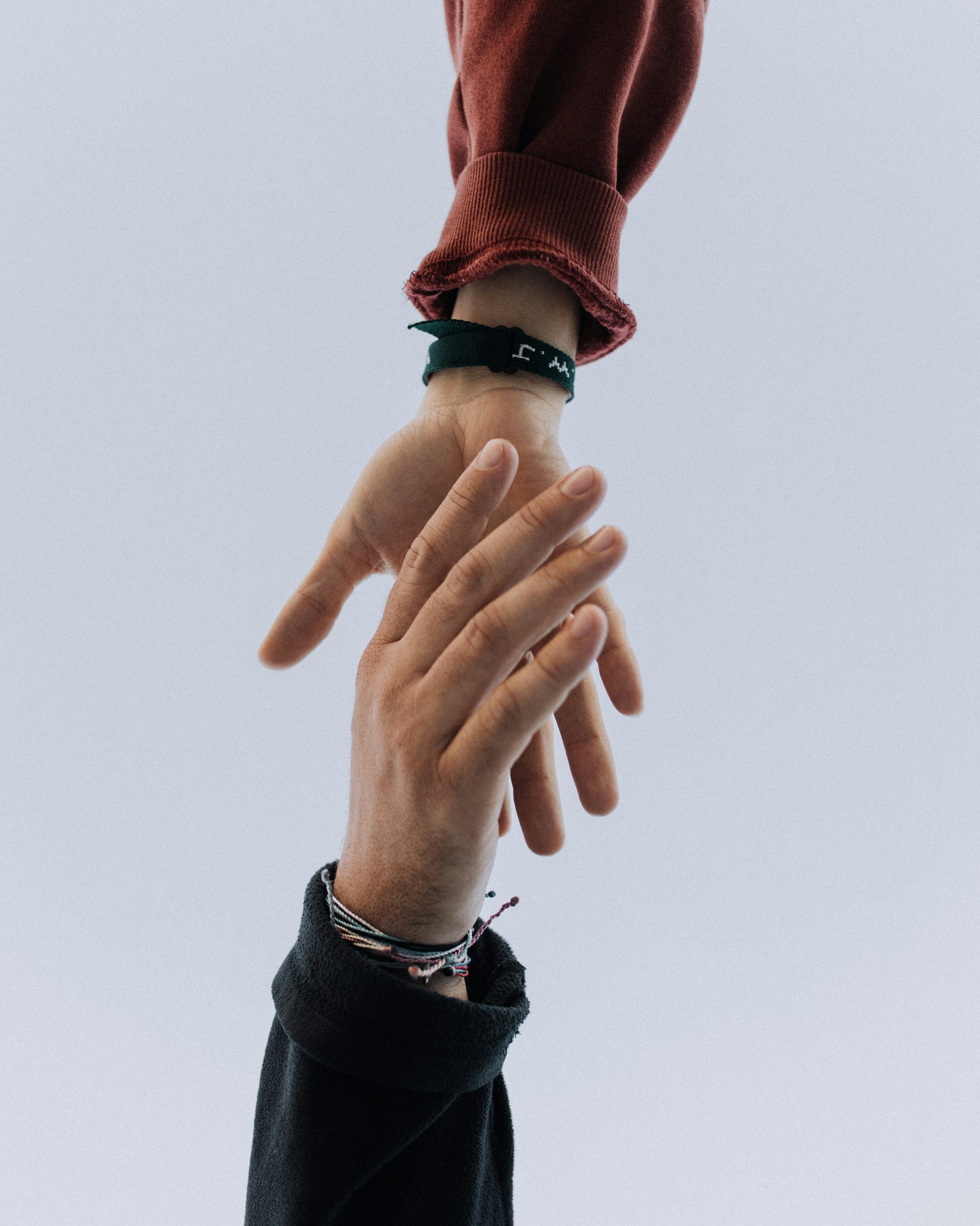 Two hands reaching toward each other